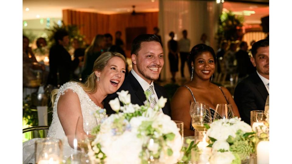 Princess Theodora and Matthew Kumar laughing at the wedding table