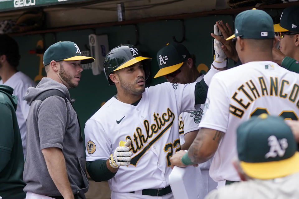 Oakland Athletics' Ramon Laureano, middle, is congratulated by teammates after hitting a home run against the Toronto Blue Jays during the sixth inning of a baseball game in Oakland, Calif., Wednesday, July 6, 2022. (AP Photo/Jeff Chiu)