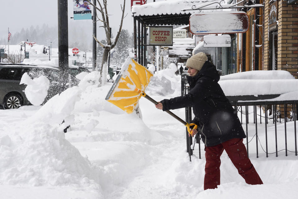 Snow is cleared from sidewalks in front of businesses during snow storm, Saturday, March 2, 2024, in downtown Truckee, Calif. (AP Photo/Brooke Hess-Homeier)