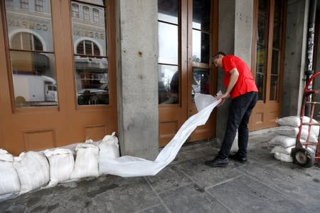 An employee places sandbags in front of a business in the French Quarter as Tropical Storm Barry approaches land in New Orleans