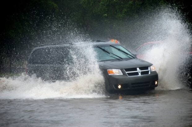 Rain water flooded streets in Regina on Friday.  (Alexander Quon/CBC - image credit)