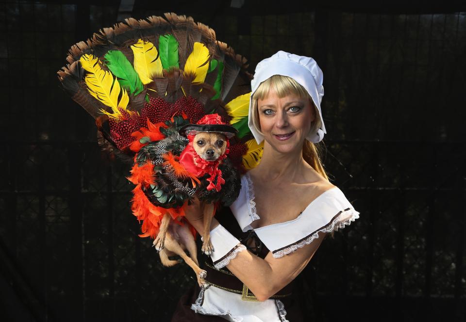 NEW YORK, NY - OCTOBER 20: Karen Biehl holds her Chihuahua Eli, who posed as a Thanksgiving turkey at the Tompkins Square Halloween Dog Parade on October 20, 2012 in New York City. Hundreds of dog owners festooned their pets for the annual event, the largest of its kind in the United States. (Photo by John Moore/Getty Images)