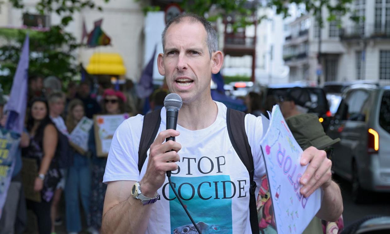 <span>Etienne Stott at an environmental protest earlier this year. Campaigners say Labour is ‘using outdated climate targets’.</span><span>Photograph: Christian Sinibaldi/The Guardian</span>