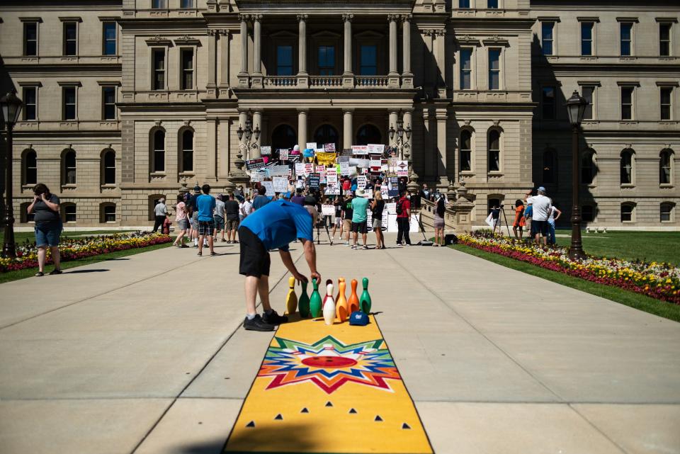 Todd "K" Kwiecien, co-owner of Royal Scot Bowling in Lansing, and others rally at the Michigan Capitol on Aug. 12, 2020, demanding that the state government allow bowling centers to open.