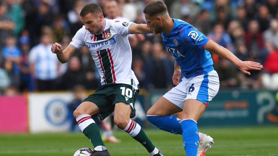 Paul Mullin battles for the ball with Stockport County's Fraser Horsfall