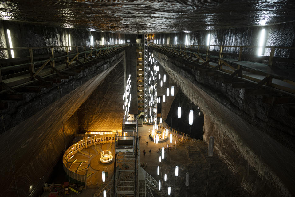 People walk inside the Salina Turda, a former salt mine turned touristic attraction, now listed by emergency authorities as a potential civil defense shelter in Turda, central Romania, Monday, Oct. 17, 2022. Fighting around Ukraine's nuclear power plants and Russia's threats to use nuclear weapons have reawakened nuclear fears in Europe. This is especially felt in countries near Ukraine, like Poland, where the government this month ordered an inventory of the country's shelters as a precaution. (AP Photo/Vadim Ghirda)