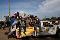 Men ride on top of a vehicle during a primaries elections event in the city of Kisumu, Kenya April 20, 2017. REUTERS/Baz Ratner