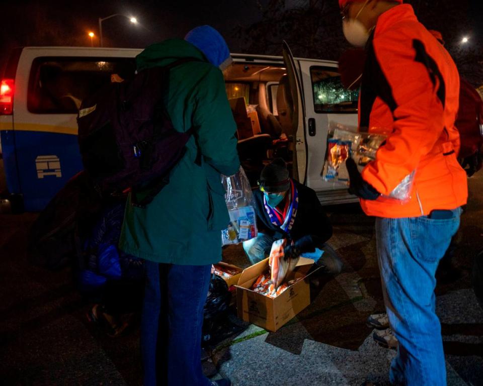 Point-in-Time Count volunteers stock up on supplies to give out to homeless people as they do their annual census of people living unhoused in Pierce County on Thursday, Jan. 27, 2022.