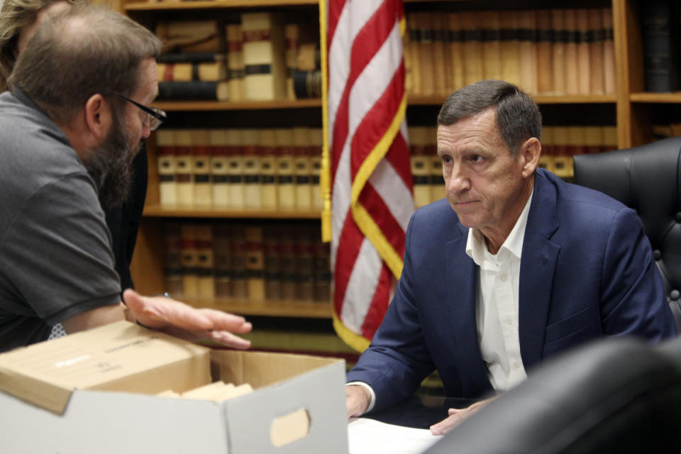 FILE- Kansas state Sen. Dennis Pyle, right, I-Hiawatha, confers with Bryan Caskey, left, state elections director for the Kansas secretary of state's office, after submitting petitions with nearly 8,900 signatures on them on Aug. 1, 2022, in Topeka, Kan. Pyle is a former Republican and one of the Legislature's most conservative members, and Republicans fear that he'll get enough of the vote to prevent them from ousting Democratic Gov. Laura Kelly. (AP Photo/John Hanna, File)