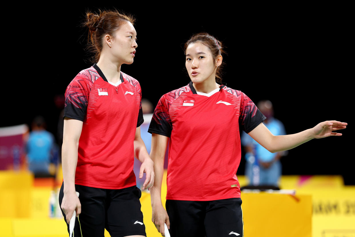 Singapore women's doubles shuttlers Jin Yujia (left) and Crystal Wong discuss tactics at the 2022 Commonwealth Games. 