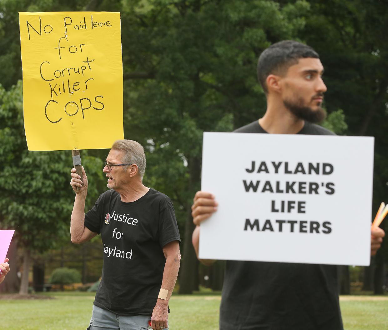 Terry Riddle of Akron, left, makes his voice heard during a vigil held for Jayland Walker in July. Riddle, who died Nov. 19, has posted about 300 signs around the city calling for "Justice for Jayland Walker," among other messages.