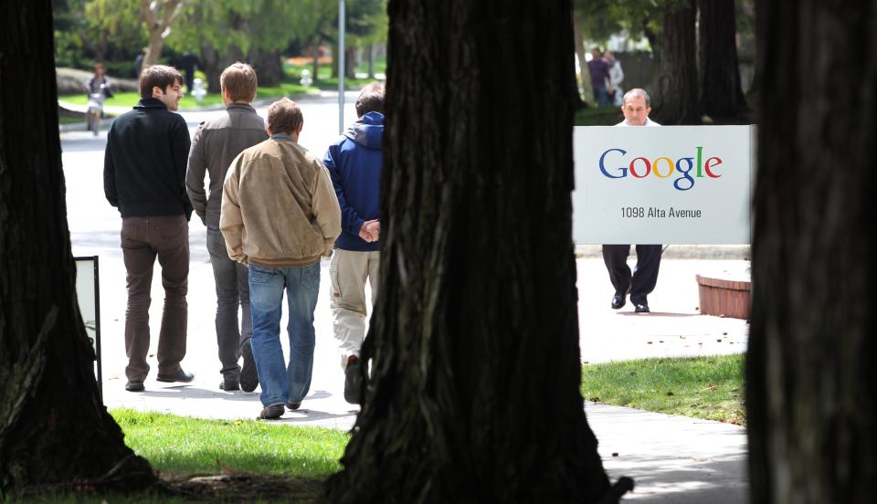 Google workers walk outside of Google headquarters in Mountain View, Calif., Thursday, April 12, 2012. Google Inc. said Thursday that it earned $2.89 billion, or $8.75 per share, in the first quarter. That’s up from $1.8 billion, or $5.51 per share, a year earlier. (AP Photo/Paul Sakuma)