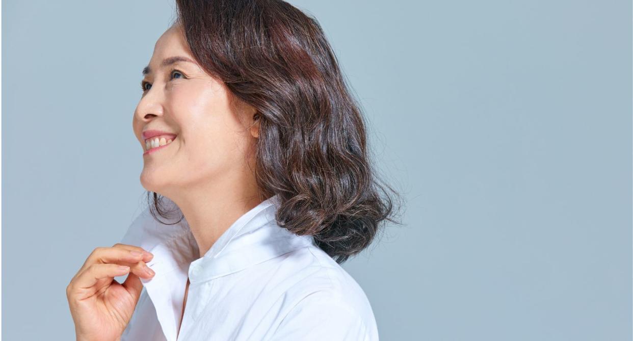 Woman smiling to the side showing menopausal hair health