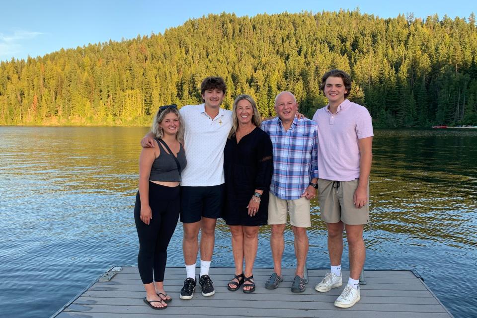 In this photo provided by Stacy Chapin, triplets Maizie, left, Ethan, second from left, and Hunter, right, pose with their parents