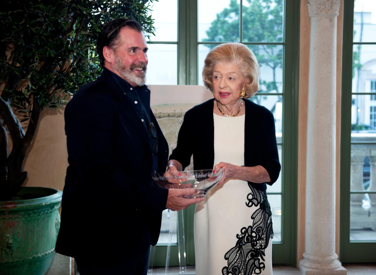 Keith Williams accepts the 2023 Lesly S. Smith Landscape Award from Lesly Smith  at the Preservation Foundation of Palm Beach March 14, 2023. The Preservation Foundation presented the award to Nievera Williams and the Town of Palm Beach for the Lake Drive Park project 