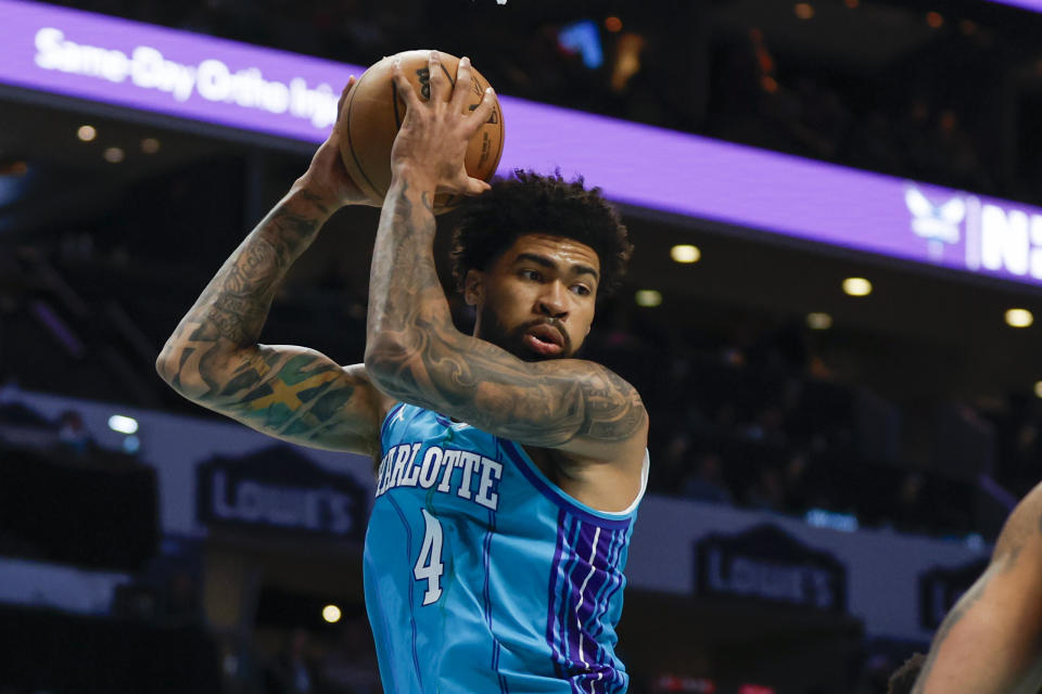 Charlotte Hornets center Nick Richards pulls down a rebound against the Memphis Grizzlies during the first half of an NBA basketball game in Charlotte, N.C., Saturday, Feb. 10, 2024. (AP Photo/Nell Redmond)