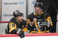 Pittsburgh Penguins' Kris Letang, left, and Erik Karlsson sit on the bench during the first period of an NHL hockey preseason game against the Buffalo Sabres in Pittsburgh, Thursday, Sept. 28, 2023. (AP Photo/Gene J. Puskar)