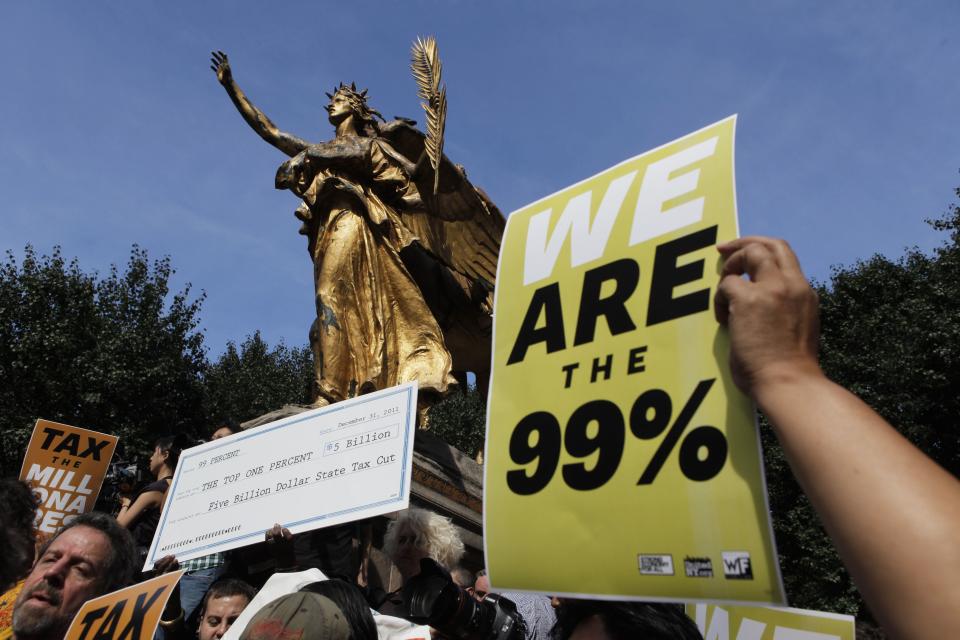 Members of the Occupy Wall St movement protest on 5th Avenue while marching through the upper east side of New York