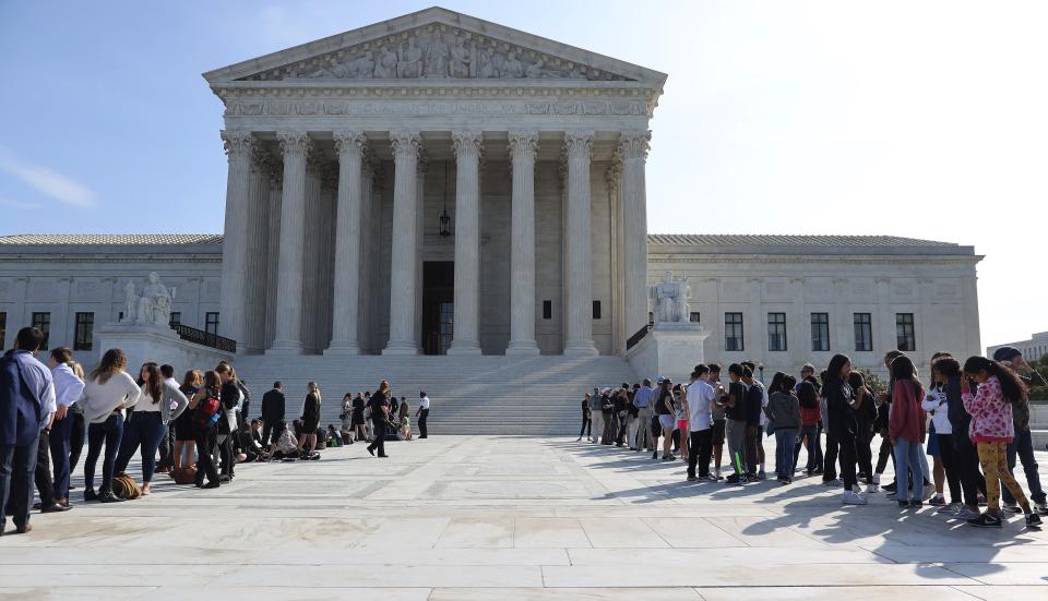 Lines of people awaited the Supreme Court's oral arguments last October, but the justices on Friday announced a second straight month of postponements due to the coronavirus pandemic.