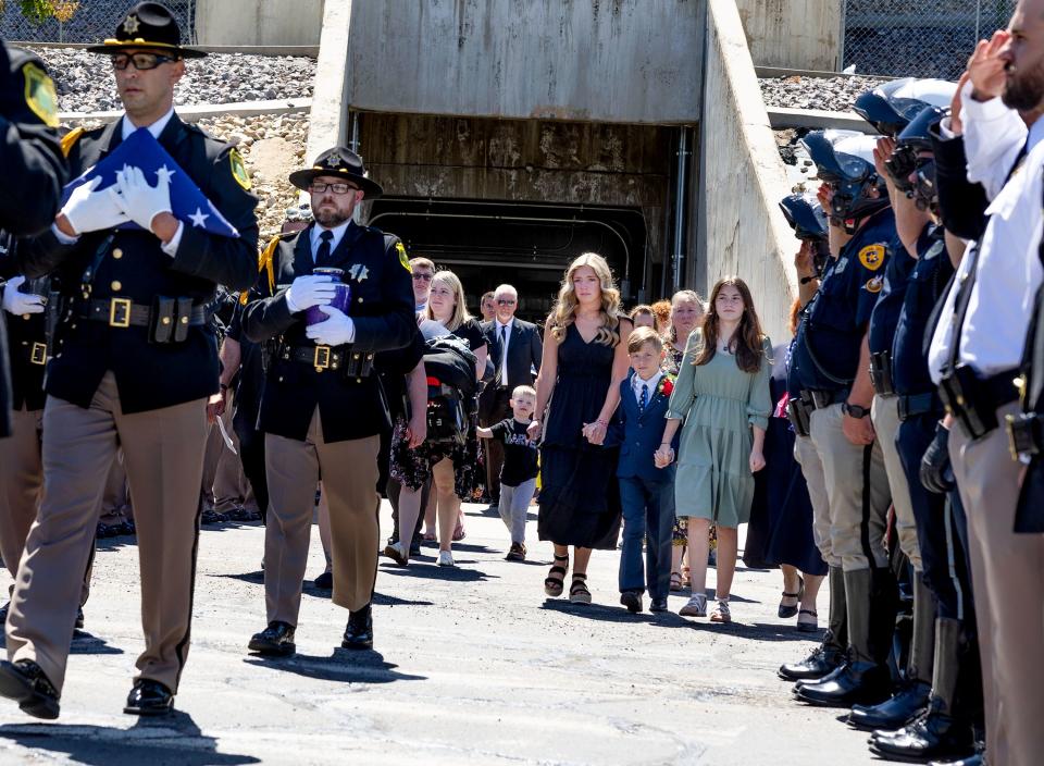 Family members of Cpl. Steven Lewis and deputy Jennifer Turner exit the Dee Events Center following the memorial service for Lewis and Turner in Ogden on Friday, July 14, 2023. The two were killed in a wrong-way crash near the intersection of South Weber Drive and Canyon Meadows Drive on Monday, July 3. | Laura Seitz, Deseret News