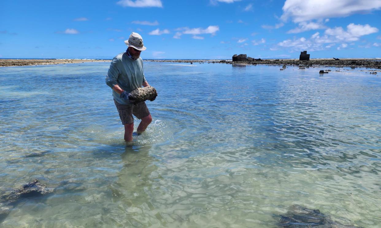 <span>An explosive ordnance disposal technician carries a Japanese projectile for destruction in the Marshall Islands in 2023 as part of a program to remove unexploded WW2 bombs.</span><span>Photograph: Golden West Humanitarian Foundation</span>