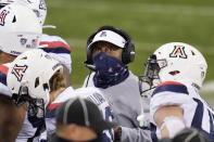 Arizona coach Kevin Sumlin looks up at the scoreboard during a timeout in the first half of the team's NCAA college football game against Washington on Saturday, Nov. 21, 2020, in Seattle. (AP Photo/Elaine Thompson)