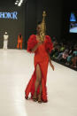 A model wears a creation by Oshobor during the Lagos Fashion Week in Lagos, Nigeria, Thursday, Oct. 26, 2023. Africa's fashion industry is rapidly growing to meet local and international demands but a lack of adequate investment still limits its full potential, UNESCO said Thursday in its new report released at this year's Lagos Fashion Week show. (AP Photo/Sunday Alamba)