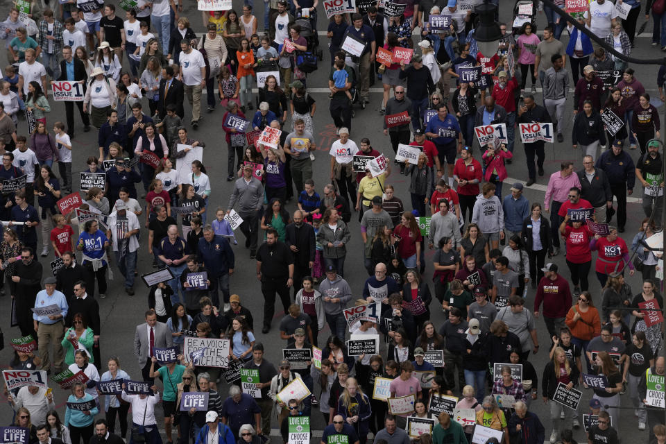 Marchers move down Front Street during the Ohio March for Life after a rally at the Ohio State House in Columbus, Ohio, Friday, Oct. 6, 2023. As campaigning escalates in Ohio’s fall fight over abortion rights, a new line of attack from opponents suggests “partial-birth” abortions would be revived if a proposed constitutional amendment passes. (AP Photo/Carolyn Kaster)