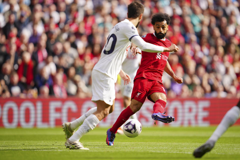 Liverpool's Mohamed Salah kicks the ball past Tottenham's Rodrigo Bentancur during the English Premier League soccer match between Liverpool and Tottenham Hotspur at Anfield Stadium in Liverpool, England, Sunday, May 5, 2024. (AP Photo/Jon Super)