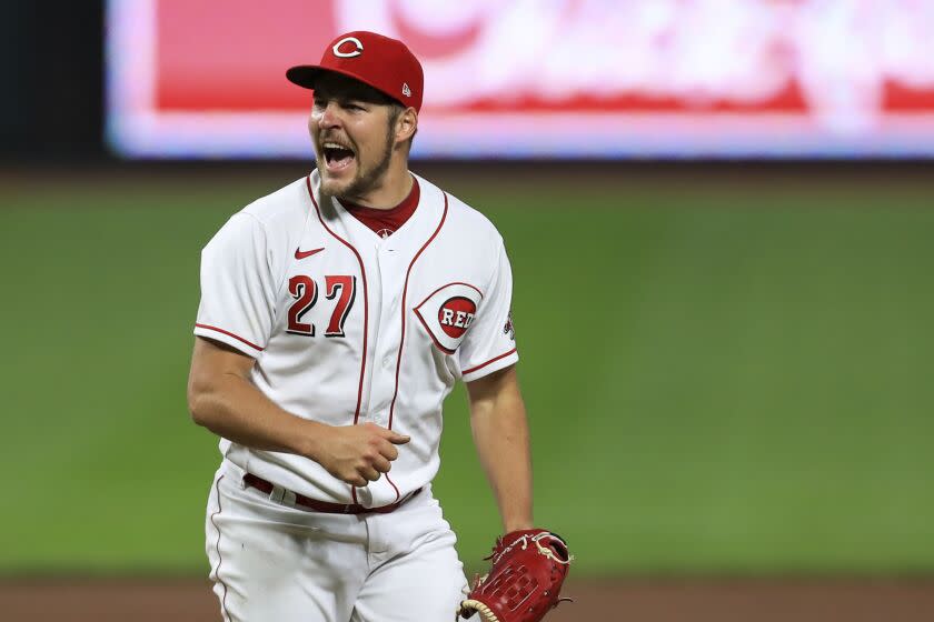 FKILE - Cincinnati Reds' Trevor Bauer reacts after recording a strikeout against Milwaukee Brewers' Christian Yelich.