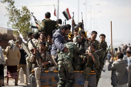 Newly recruited Houthi militants ride on the back of a patrol truck as they leave the site of a gathering held by tribesmen loyal to the Houthi movement, in Yemen's capital Sanaa December 14, 2015. REUTERS/Khaled Abdullah