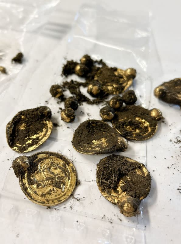 Handout photo released on September 7, 2023 by the Museum of Archaeology and the University of Stavanger (UiS), south-western Norway, shows coin-like gold pendants that are part of a gold treasure found in August 2023 by an amateur archaeologist with the help of a metal detector on the island of Rennesoy in Stavanger. The treasure consists of nine gold medallions and pearls that once formed a luxurious necklace, as well as three gold rings, the University of Stavanger announced on September 7, 2023. It was discovered at the end of August on a farmer's property near Stavanger by an amateur archaeologist, Erlend Bore, who had bought a metal detector after his doctor and physiotherapist advised him to be more physically active. (Photo by Anniken Celine Berger / various sources / AFP) / Norway OUT (Photo by ANNIKEN CELINE BERGER/NTB/Arkeologisk museum, UiS/AFP via Getty Images)<p>ANNIKEN CELINE BERGER/Getty Images</p>