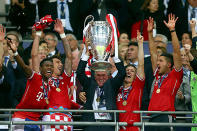 Head Coach Jupp Heynckes of Bayern Muenchen lifts the trophy after winning the UEFA Champions League.
