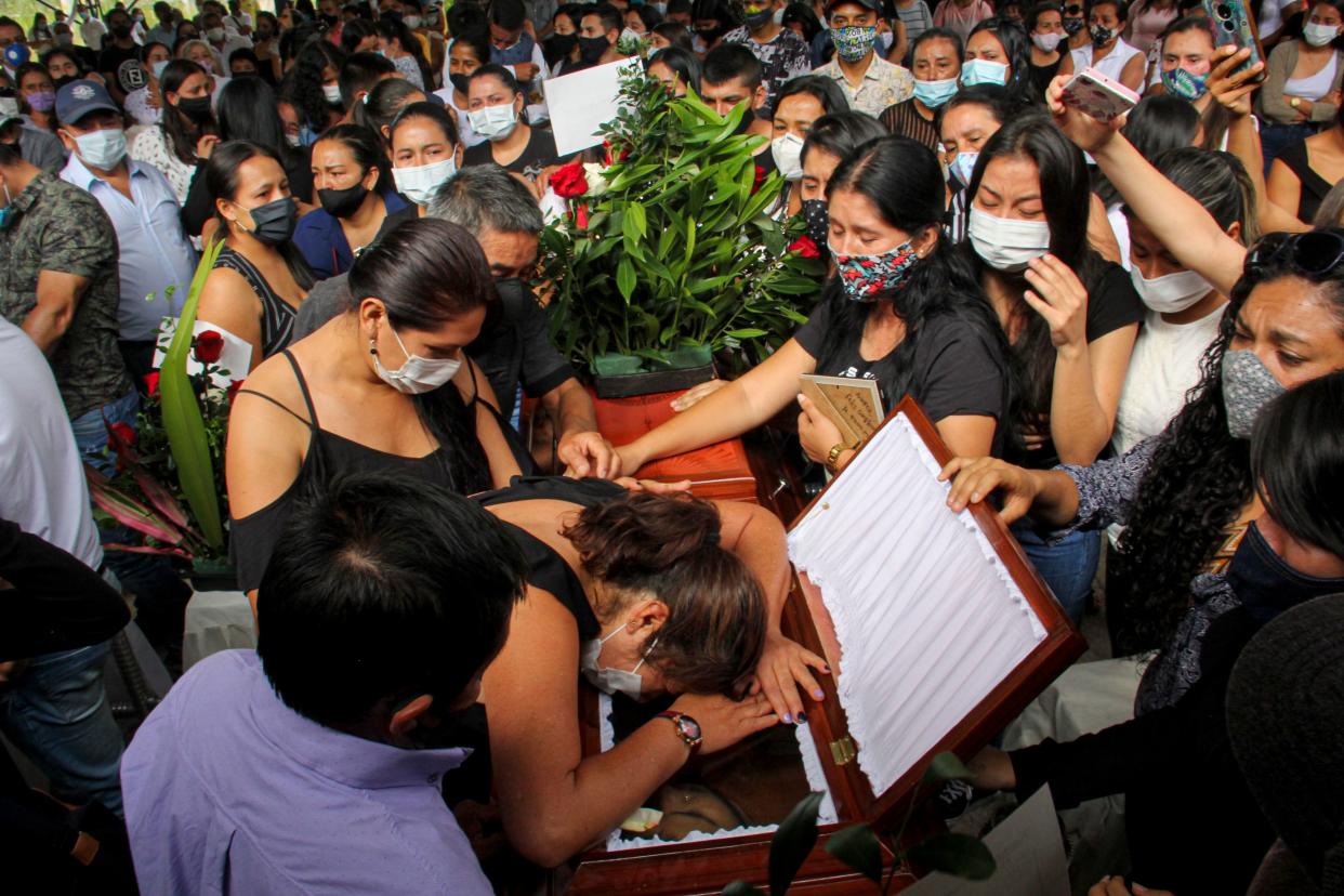 TOPSHOT - Friends and relatives mourn next to the coffin of one of the eight youngsters murdered in a rural area of Samaniego, Narino department, Colombia, on August 17, 2020. - Colombian authorities and NGOs warned on Sunday about the deterioration of security in the country, after thirteen young people and adolescents were killed in a period of four days amid the confinement measures to stop the coronavirus. (Photo by Leonardo CASTRO / AFP) (Photo by LEONARDO CASTRO/AFP via Getty Images)