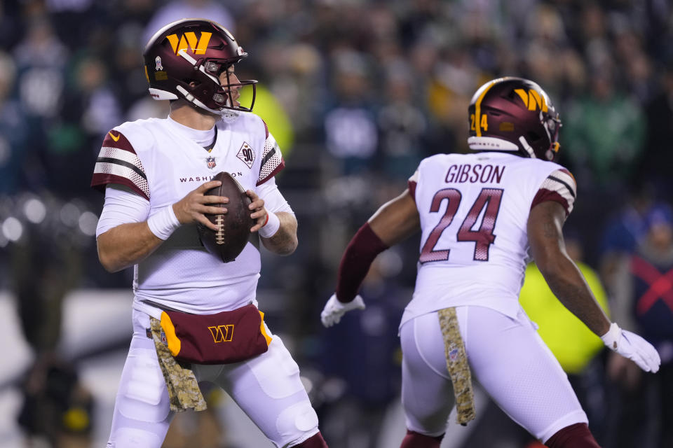 Washington Commanders quarterback Taylor Heinicke (4) works in the pocket against the Philadelphia Eagles during the first half of an NFL football game, Monday, Nov. 14, 2022, in Philadelphia. (AP Photo/Matt Rourke)