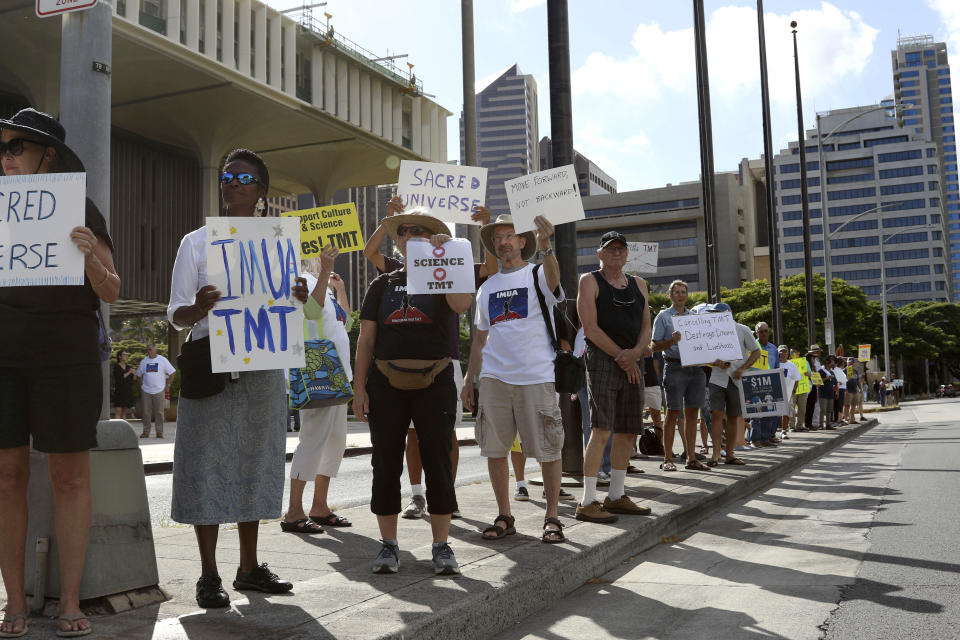 Supporters of the Thirty Meter Telescope gather for a rally outside the Hawaii State Capitol in Honolulu on Thursday, July 25, 2019. Supporters said the giant telescope planned for Hawaii's tallest mountain will enhance humanity's knowledge of the universe and bring quality, high-paying jobs, as protesters blocked construction for a second week. (AP Photo/Audrey McAvoy)