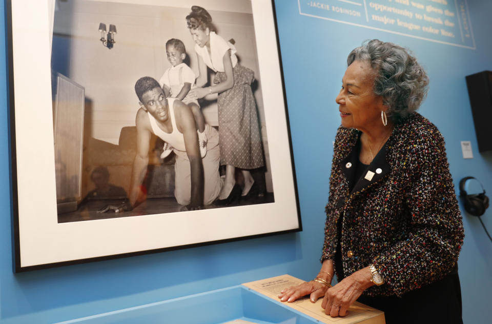 Rachel Robinson, widow of the late Jackie Robinson, looks at a photograph of her husband, herself and their son Jackie Jr., displayed at the Museum of the City of New York Thursday, Jan. 31, 2019, in New York part of an exhibition celebrating Robinson's 100th birthday. "In the Dugout with Jackie Robinson," mounted in collaboration with The Jackie Robinson Foundation, features 30 photographs originally shot for Look Magazine (most never published), rare home movies of the Robinson family plus memorabilia related to Robinson's career. (AP Photo/Kathy Willens)