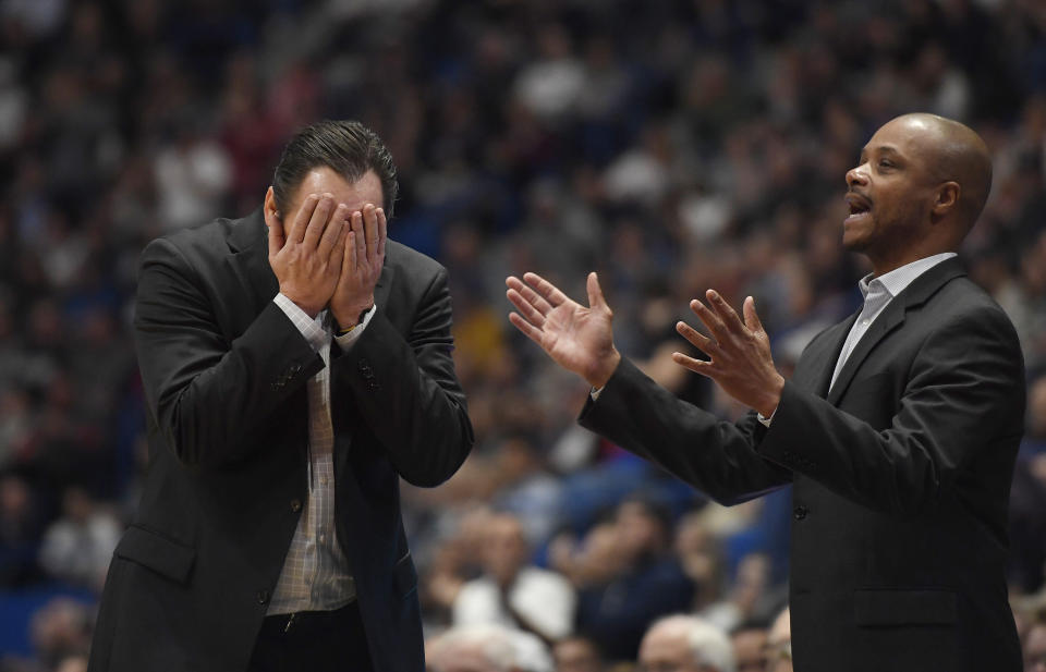 Wichita State head coach Gregg Marshall, left, and assistant coach Isaac Brown are shown during the second half of an NCAA college basketball game in Hartford, Conn., Sunday, Jan. 12, 2020. Wichita State coach Gregg Marshall resigned Tuesday, Nov. 17, 2020, following an investigation into allegations of verbal and physical abuse, ending a tenure that soared to the Final Four and crashed on the eve of the upcoming season. Shockers assistant coach Isaac Brown will serve as the interim coach. (AP Photo/Jessica Hill, File)