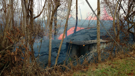 Lava is seen spewing from fissures in Pahoa, Hawaii, U.S., May 22, 2018 in this picture obtained from social media. Kris Burmeister/via REUTERS