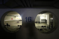 People wait in a converted underground car park vaccination centre in Ebersberg near Munich, Germany, Saturday, May 15, 2021. Hundreds of people have lined up at an improvised vaccination center near Munich to get one of 1,000 doses of the AstraZeneca coronavirus vaccine that were on offer. Police said that around 850 people were standing in line at around 10 a.m. -- and some of them had arrived as early as 5 a.m. (AP Photo/Matthias Schrader)