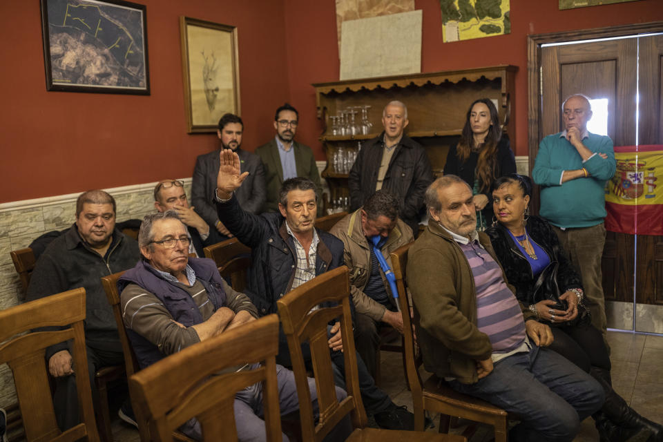 In this April 10, 2019 photo, farmers attend a meeting with Spanish far right party Vox at a bar in Brazatortas, on the edge of the Alcudia valley, central Spain. The April 28 election also comes as Spain's traditional bipartisan politics have crumbled into five main contenders, spurring the race for votes in the overrepresented hinterland, where nearly one third of seats in the parliament's lower house are up for grabs. Following the trotted path of far-right parties elsewhere, Vox is posed to grab 29 to 37 deputies in the national parliament on Sunday, a big splash for a party that only last year made its first big advance with a win in the regional election in Andalusia, a Socialist stronghold. (AP Photo/Bernat Armangue)