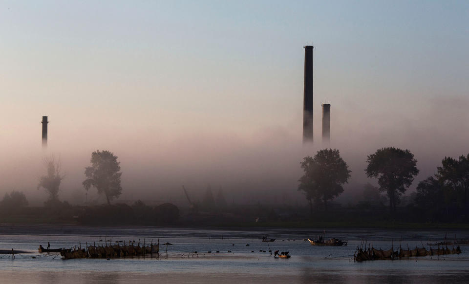 <p>North Korean fishermen are seen at sunrise on the Yalu river in the border city of Dandong, Liaoning province, northern China across from the city of Sinuiju, North Korea on May 24, 2017 in Dandong, China. (Photo: Kevin Frayer/Getty Images) </p>