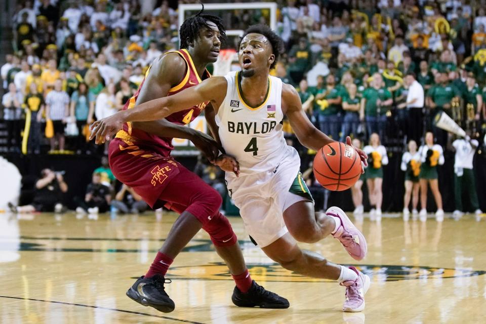 Baylor guard LJ Cryer (4) dribbles around Iowa State  guard Demarion Watson during their game at Ferrell Center.