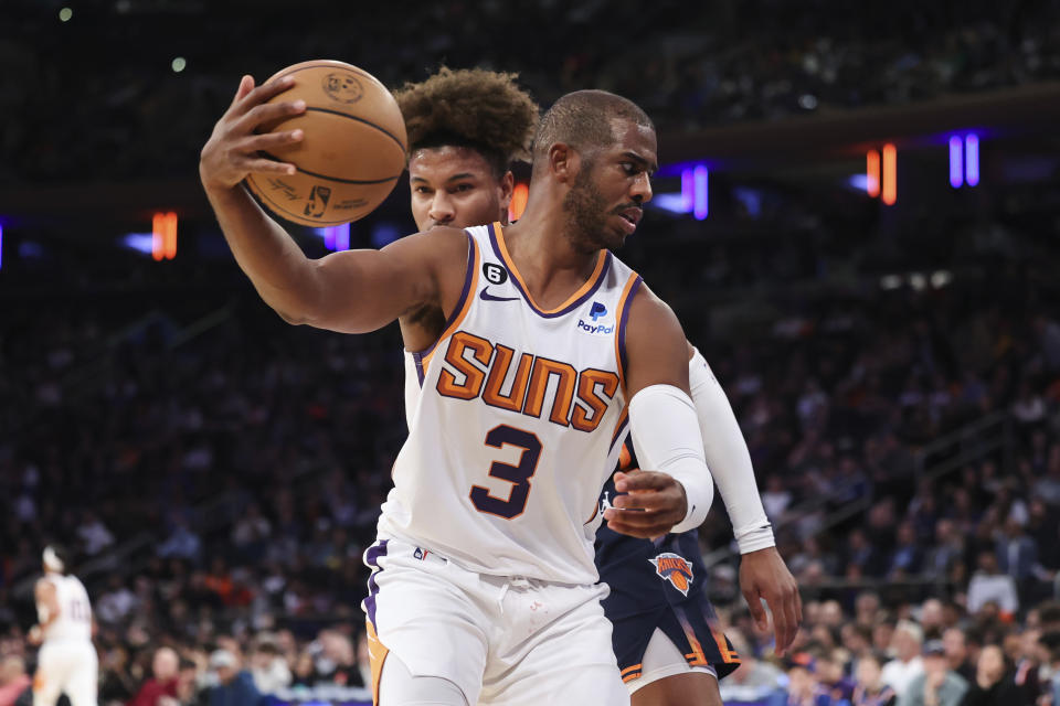 Phoenix Suns guard Chris Paul (3) prepares to dribble downcourt as New York Knicks guard Miles McBride defends during the first half of an NBA basketball game, Monday, Jan. 2, 2023, in New York. (AP Photo/Jessie Alcheh)