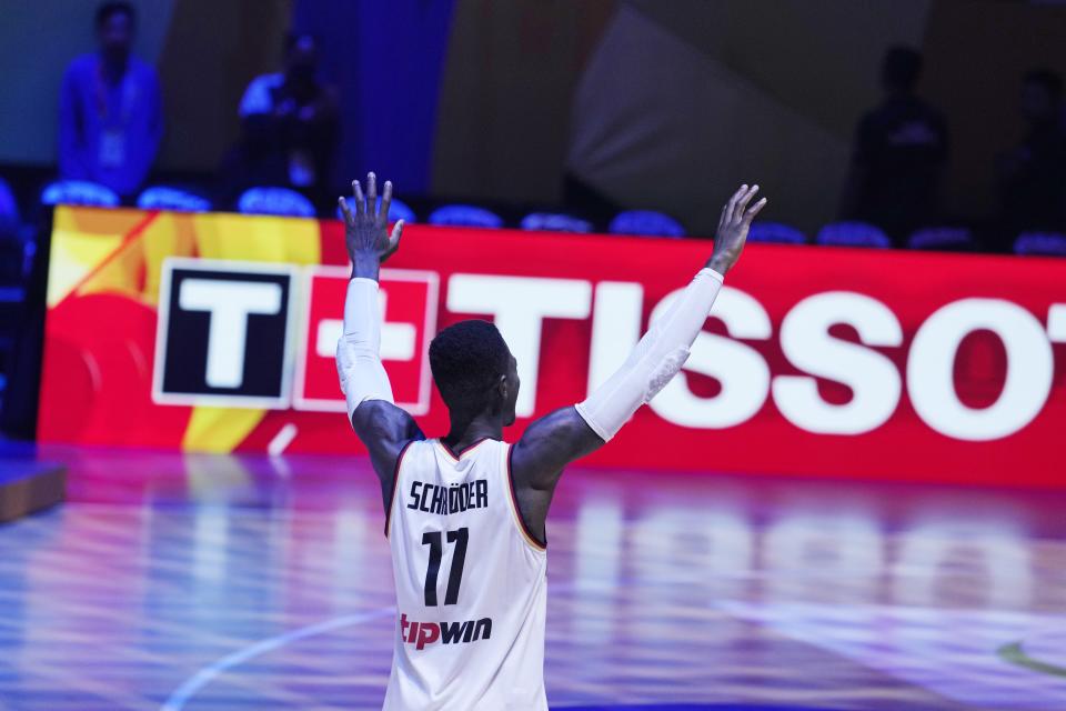 Germany guard Dennis Schroder (17) celebrates as he goes out to receive the MVP award after winning the championship game of the Basketball World Cup against Serbia in Manila, Philippines, Sunday, Sept. 10, 2023. (AP Photo/Michael Conroy)