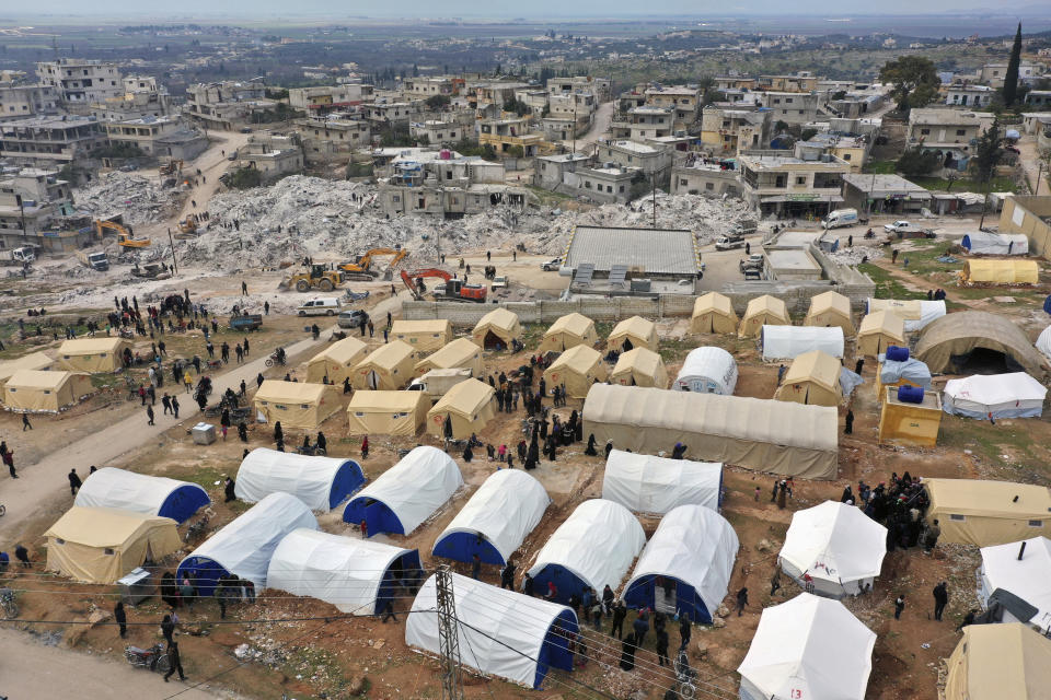 FILE - Volunteers set up tents for Families who lost their homes in a devastating earthquake to provide them shelter and food near destroyed buildings in the town of Harem, Idlib province, Syria, Saturday, Feb. 11, 2023. After years of war, residents of areas in northwest Syria struck by a massive earthquake are grappling with their new and worsening reality. (AP Photo/Ghaith Alsayed, File)