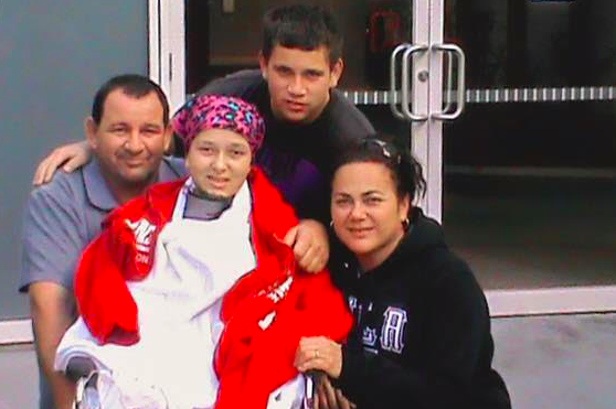 Giovanna (centre) with father Fred, brother Nando and mother Angela during her treatment. Source: Angela Ienco/Supplied