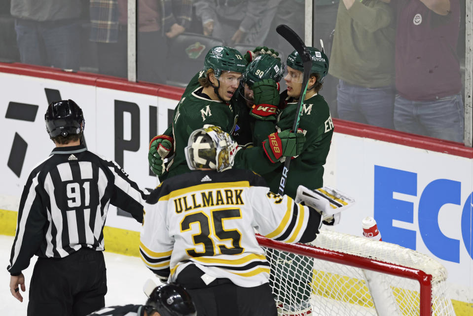 Minnesota Wild left wing Marcus Johansson (90) celebrates with teammates left wing Matt Boldy (12) and center Joel Eriksson Ek (14) after Johansson scored a goal during the first period of an NHL hockey game against the Boston Bruins, Sunday, March 18, 2023, in St. Paul, Minn. (AP Photo/Stacy Bengs)