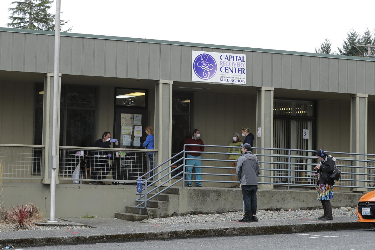 FILE - Patients line up to pick up medication for opioid addiction at a clinic in Olympia, Wash., on March 27, 2020. A temporary law that makes possession of small amounts of drugs a misdemeanor expires on July 1, so if lawmakers fail to pass a bill, Washington would become the second state — after neighboring Oregon — to decriminalize drug possession. Lawmakers said Tuesday, May 2, 2023, they were increasingly optimistic a compromise will be reached to avoid those consequences. (AP Photo/Ted S. Warren, File)