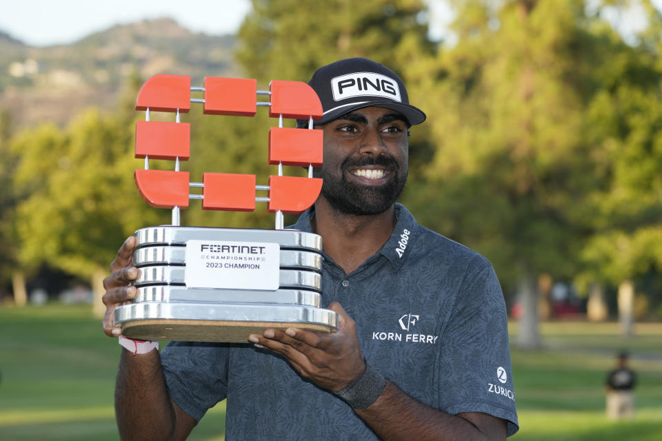 Sahith Theegala poses with his trophy on the 18th green of the Silverado Resort North Course after winning the Fortinet Championship PGA golf tournament in Napa, Calif., Sunday, Sept. 17, 2023. (AP Photo/Eric Risberg)